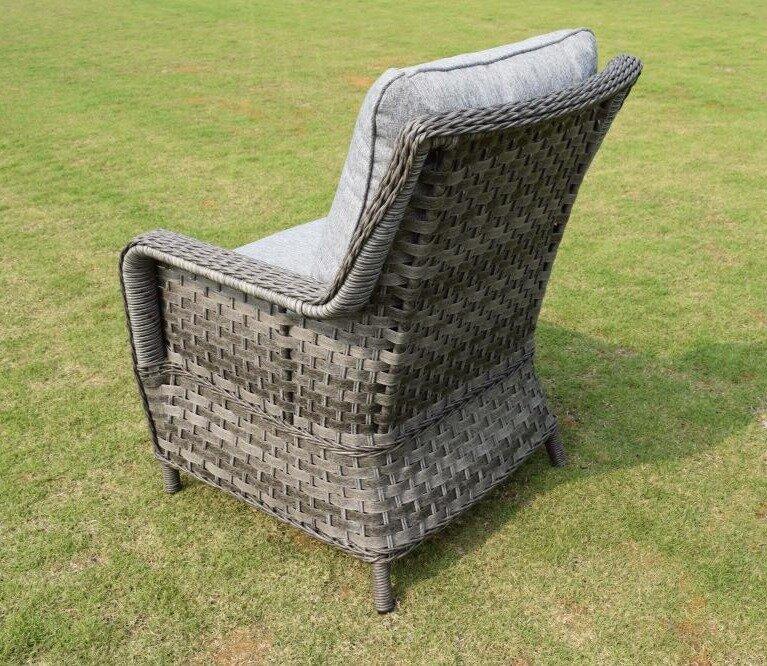 Wicker outdoor armchair with grey cushions on a lawn, showcasing intricate woven design and sturdy structure, perfect for garden or patio relaxation and seating.