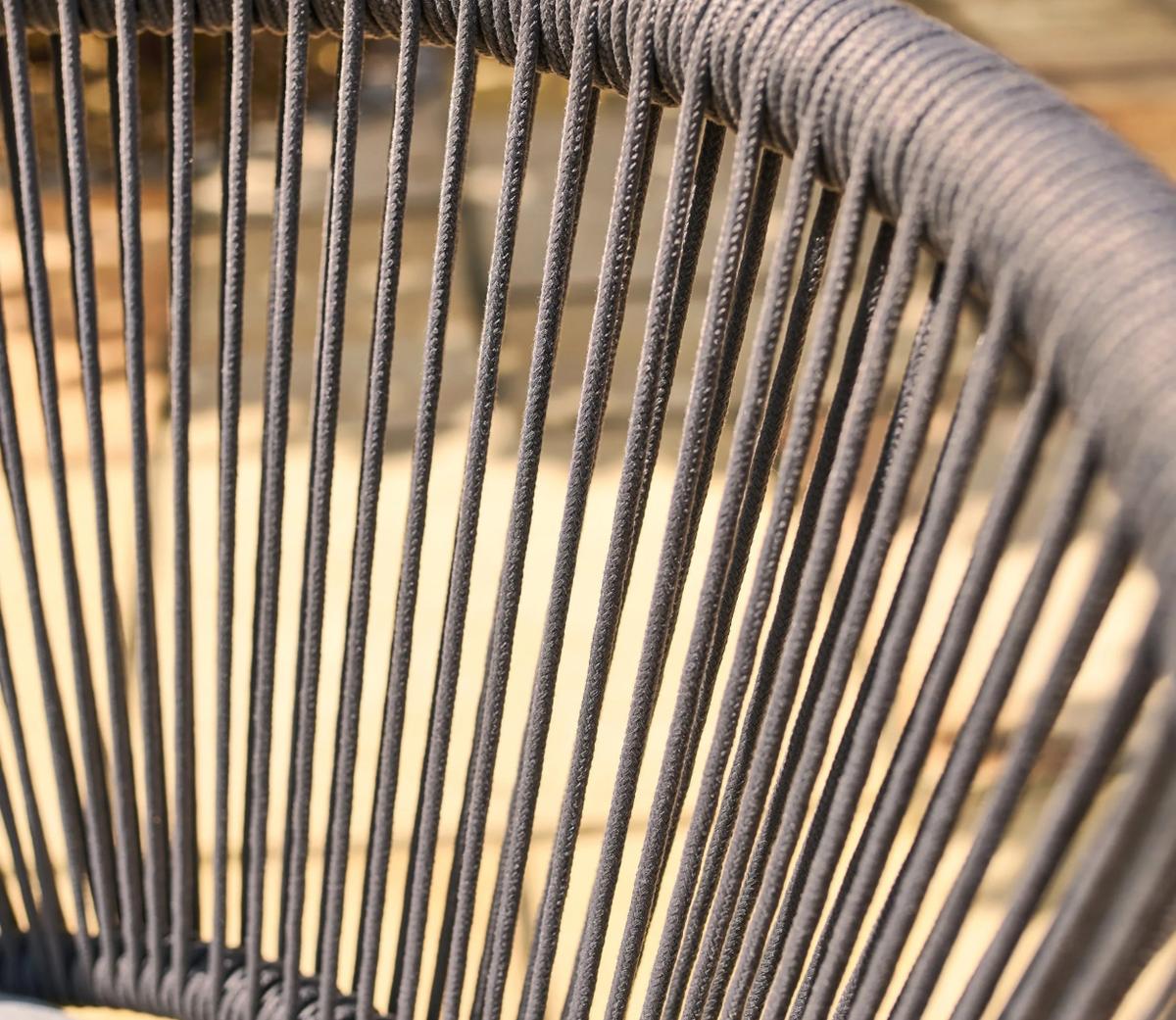 Close-up of a stylish modern chair featuring tightly woven dark grey ropes, showcasing intricate craftsmanship on a sunlit background, ideal for contemporary outdoor decor.