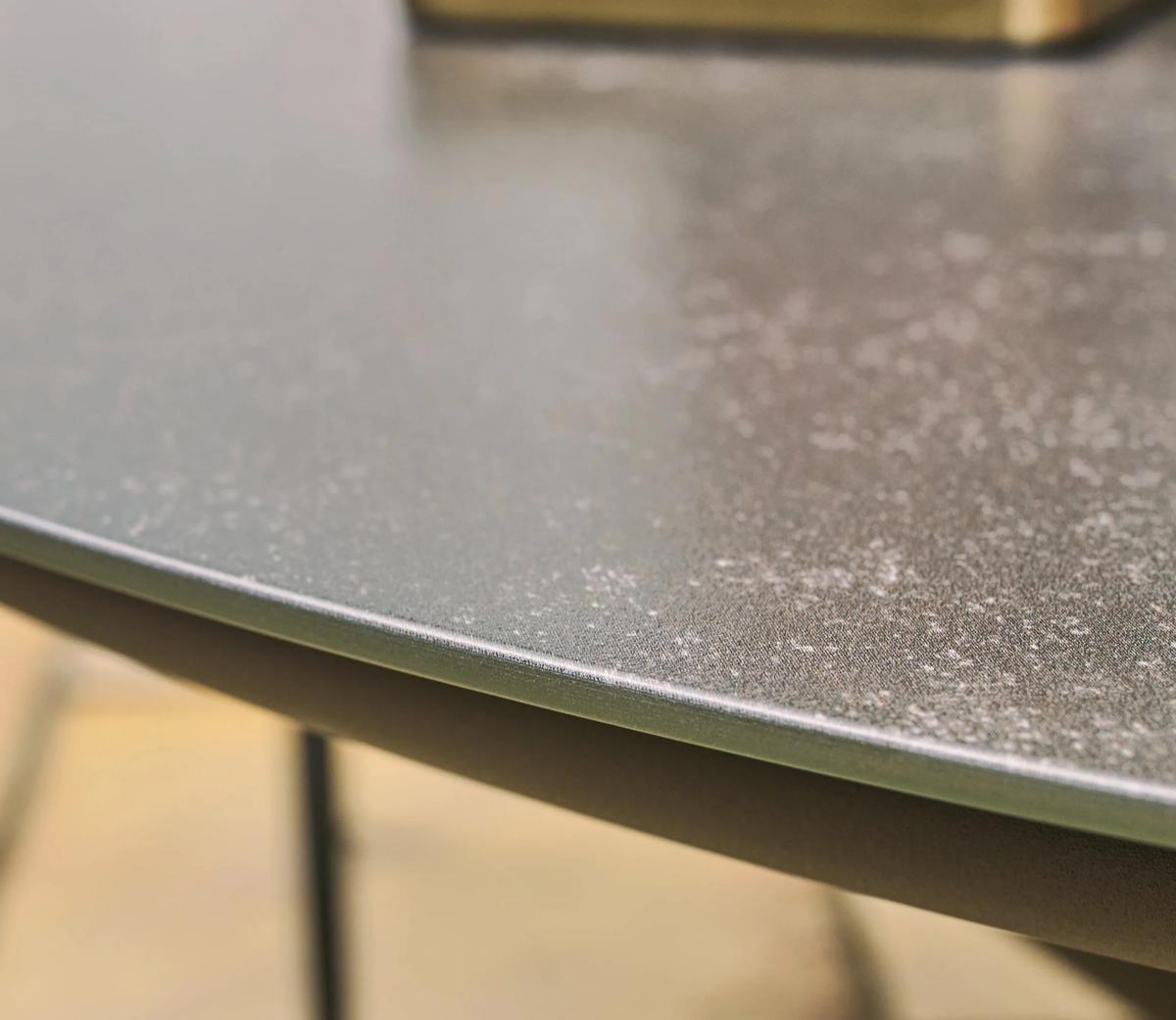 Close-up of a sleek, textured grey tabletop with a smooth edge, highlighting its premium quality and modern design perfect for contemporary living spaces.