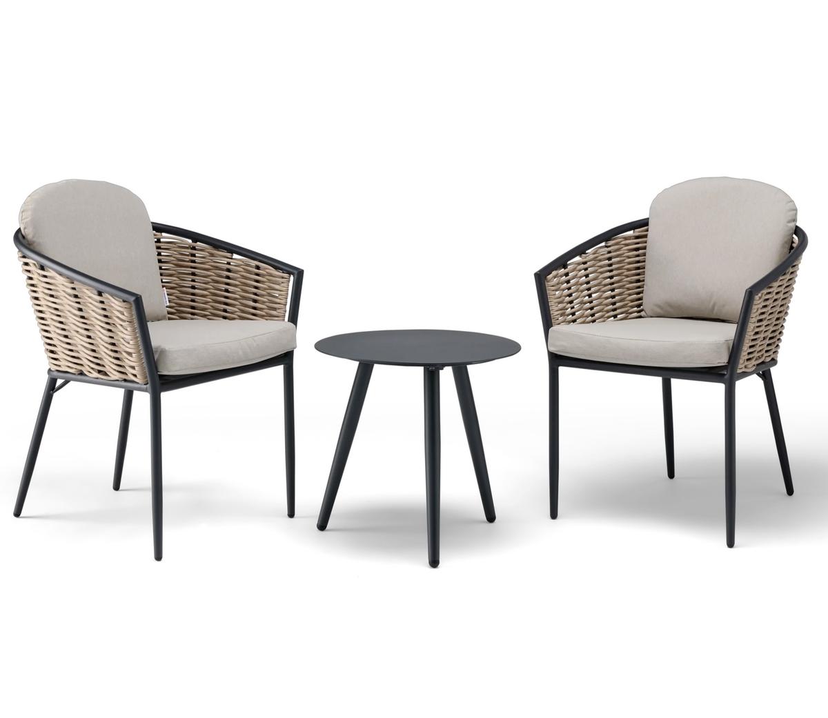 Outdoor patio set with two beige-cushioned rattan chairs and a round black metal table, ideal for garden seating or terrace, combining comfort and style.
