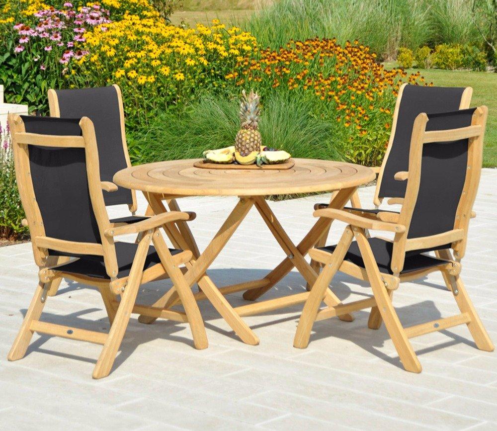Teak outdoor dining set featuring four foldable chairs with black fabric and a round wooden table. Perfect for garden settings with blooming flowers in the background.