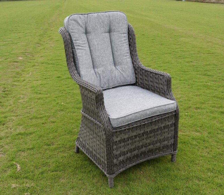 Rattan garden armchair with grey cushioned seating, perfect for outdoor relaxation. Features a stylish woven wicker design, set on a green lawn. Ideal for patios.
