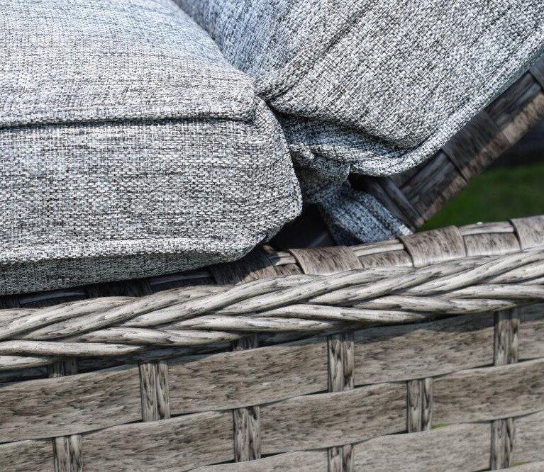 Grey woven outdoor cushions on textured rattan garden furniture, showcasing a modern, comfy design suitable for patio environments. Luxurious and weather-resistant.