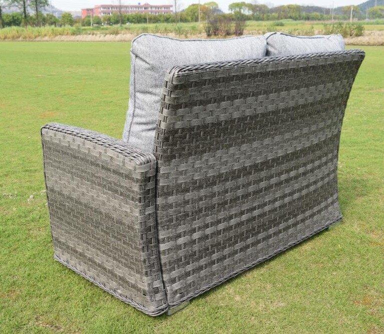 Outdoor wicker sofa with grey cushions, set on a grassy lawn. The back view highlights the intricate woven design, showcasing durability and weather resistance.
