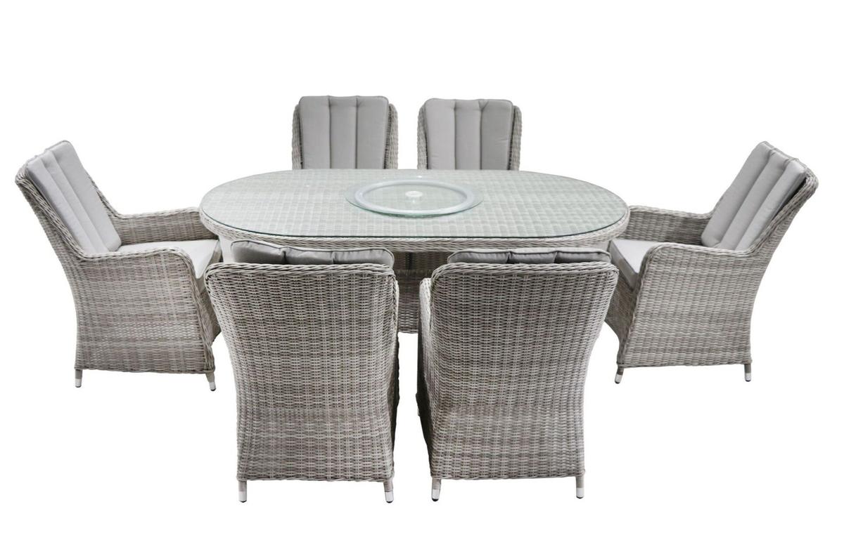Oval outdoor dining set with six grey cushioned wicker chairs and a glass top table, showcasing a modern, stylish design perfect for garden or patio spaces.