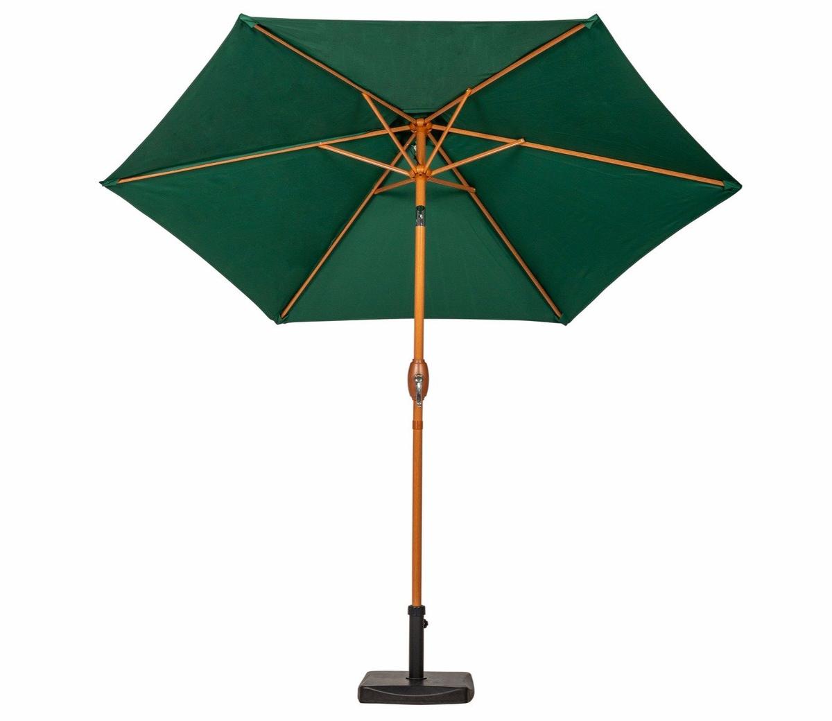 Green patio umbrella with a wooden pole and a sturdy black base, fully open. Ideal for outdoor use, providing shade in gardens or patios with robust design.